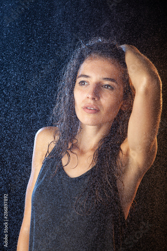 Closeup portrait of sexy wet brunette in black shirt