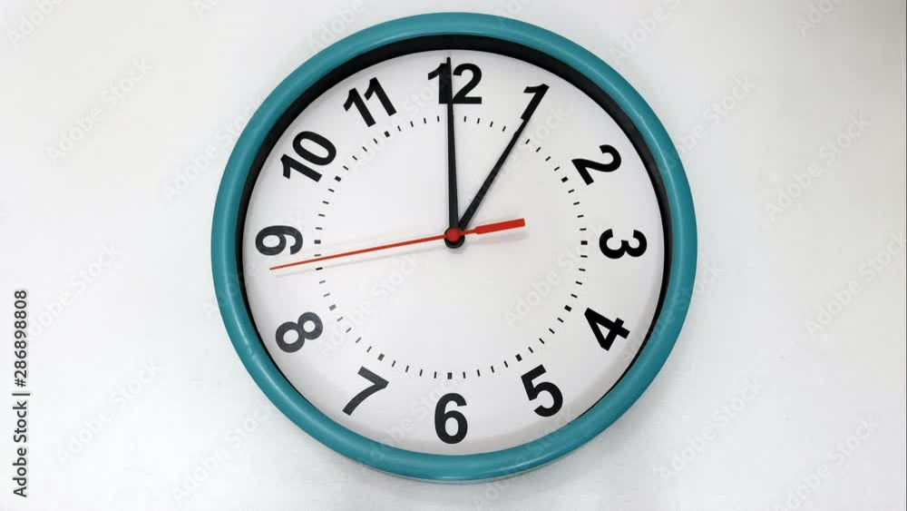 The White Clock With Black And Red Arrows Shows The Time One Hours Timelapse. The White Clock With Black And Red Arrows Shows The Time One Hours Timelapse.