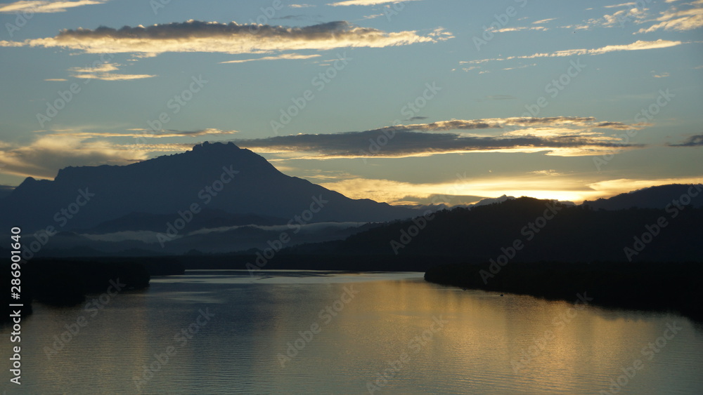 Mount Kinabalu during sunrise over Sulaman River Bridge Mount Kinabalu during sunrise over Sulaman River Bridge