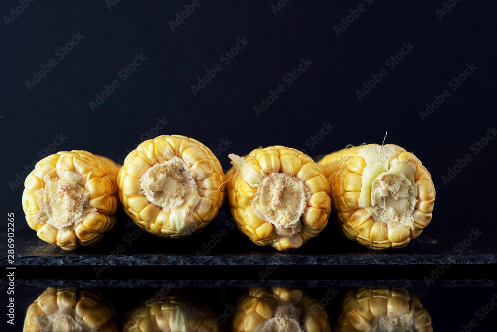 Ripe yellow corn on a dark background