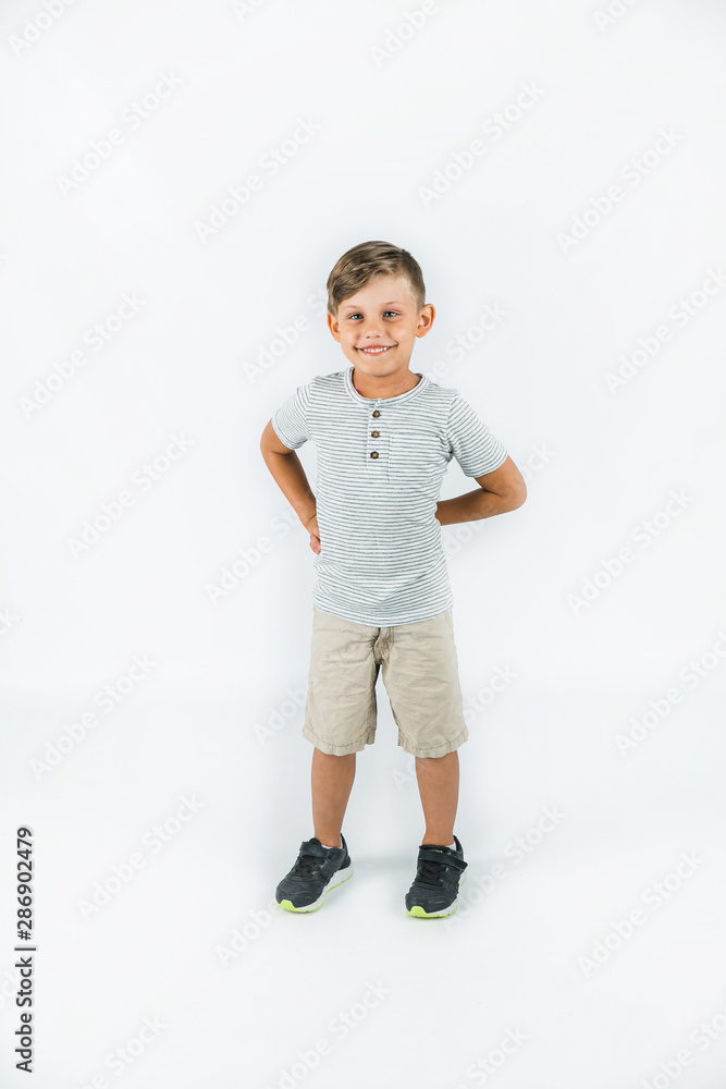Little boy with autism standing on a white background feeling happy and smiling Little boy with autism standing on a white background feeling happy and smiling