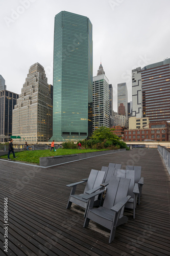 Rainy and abandoned chairs in autumn on Pier 15, East River Esplanade