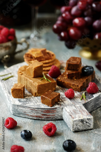 Norwegian cheese brunost on the cutting board. selective focus photo