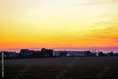The image of russian village at sunset
