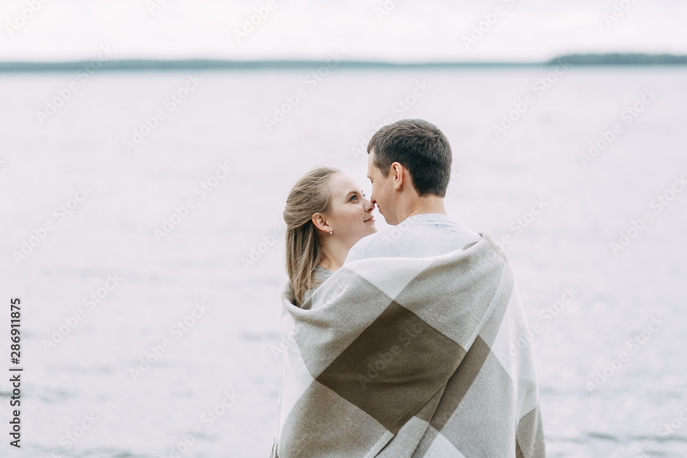 a walk in the woods by the pier. young couple walking on the lake. a walk in the woods by the pier. young couple walking on the lake.