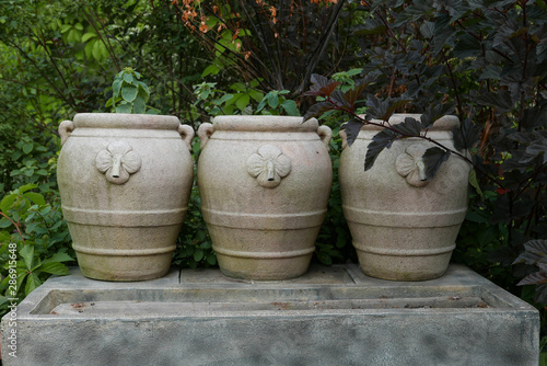 Three beautiful clay pottery vases on the autumn garden © sharafmaksumov