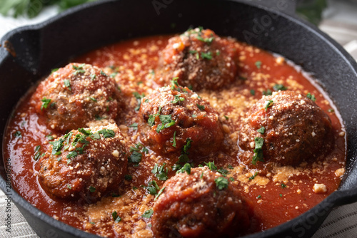 meatballs with tomato sauce in cast iron skillet photo
