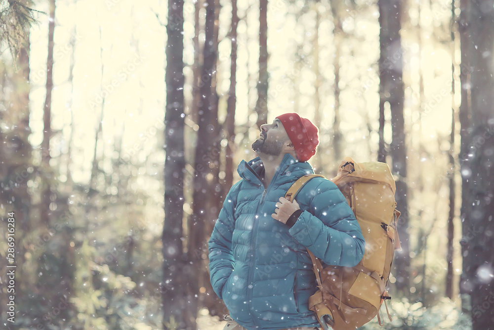 winter landscape man with a backpack / nature landscape a man on a hike with equipment in snowy weather in Canada winter landscape man with a backpack / nature landscape a man on a hike with equipment in snowy weather in Canada