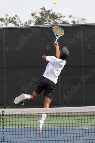 Young boy making a save during a tennis match © Joe