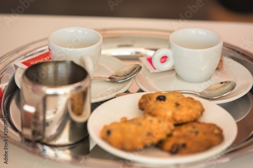 Photo of cookies and coffee on table at restaurant