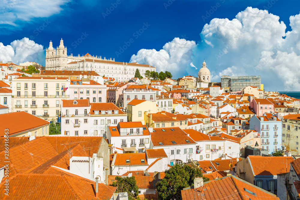 Beautiful cityscape of Lisbon with historical buildings and huge cumulus clouds, Portugal