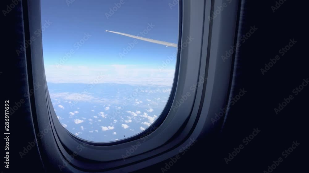 View from airplane window to the sky and plane wing, nobody. Travel destinations View from airplane window to the sky and plane wing, nobody. Travel destinations