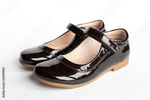 children's classic leather school shoes for a girl, school uniform isolated on a white background. back to school concept