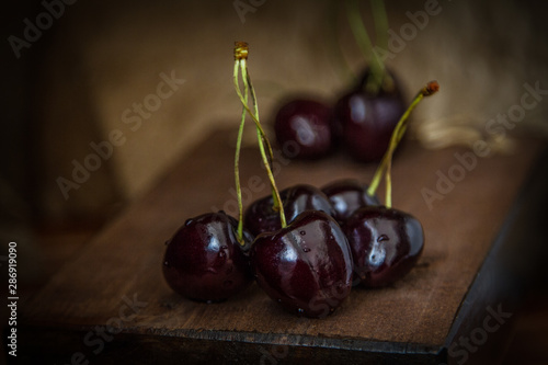 Natural cherry in a basket and on a black background.