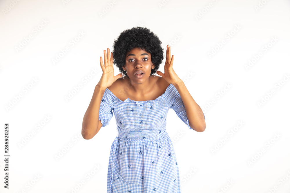 Beautiful female half-length portrait on white studio background. Young emotional african-american woman in blue dress. Facial expression, human emotions concept. Shocked, astonished, wondered. Beautiful female half-length portrait on white studio background. Young emotional african-american woman in blue dress. Facial expression, human emotions concept. Shocked, astonished, wondered.
