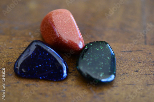 Tumbled Red Goldstone, Blue Goldstone, and Green Goldstone! Sparkling healing crystals, magical witchy stones for reiki healing and energy work! Rainbow of tumbled stones natural lighting photoagraphy