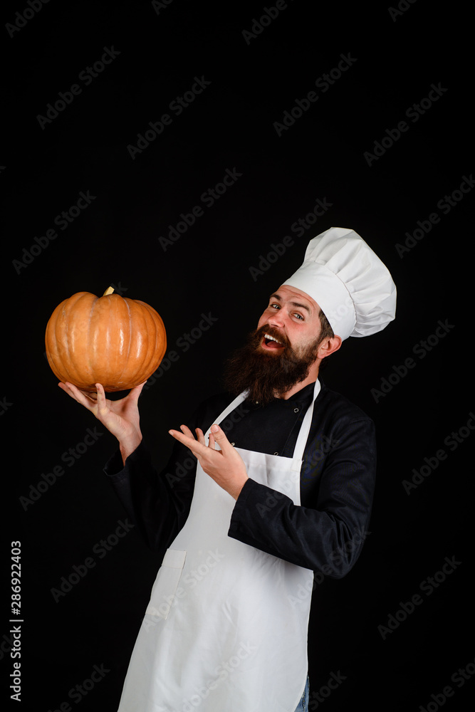 Healthy organic harvest vegetables. Chef man in white apron presenting pumpkin for culinary. Bearded cook in chef uniform with pumpkin. Autumn food concept. Thanksgiving seasonal cooking ingredients. Healthy organic harvest vegetables. Chef man in white apron presenting pumpkin for culinary. Bearded cook in chef uniform with pumpkin. Autumn food concept. Thanksgiving seasonal cooking ingredients.