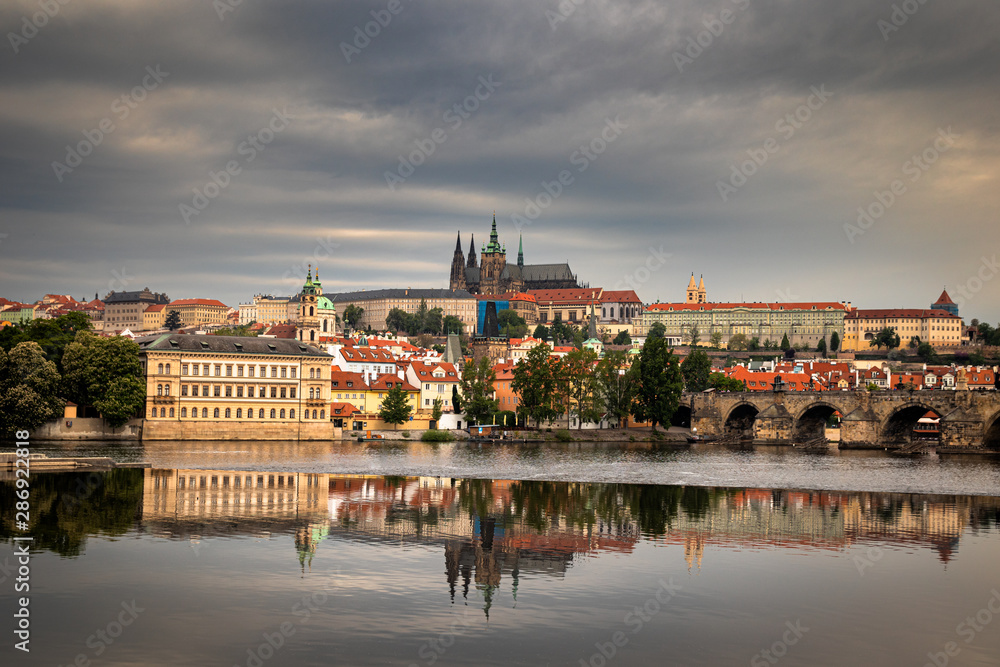 Beautiful Vltava river in Prague with old town and historical buildings in the background