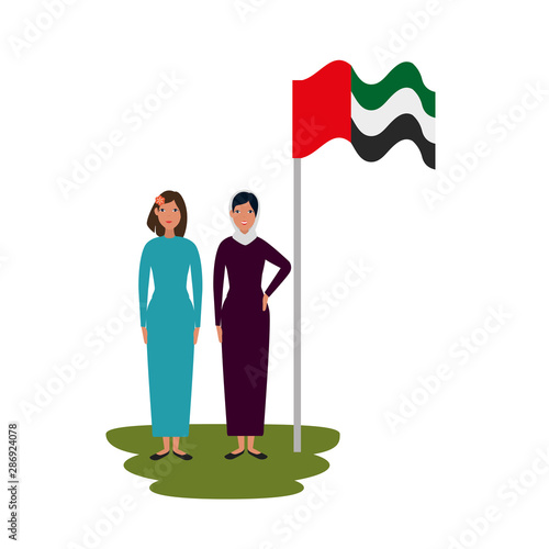 islamic women with traditional burka and arabia flag in pole