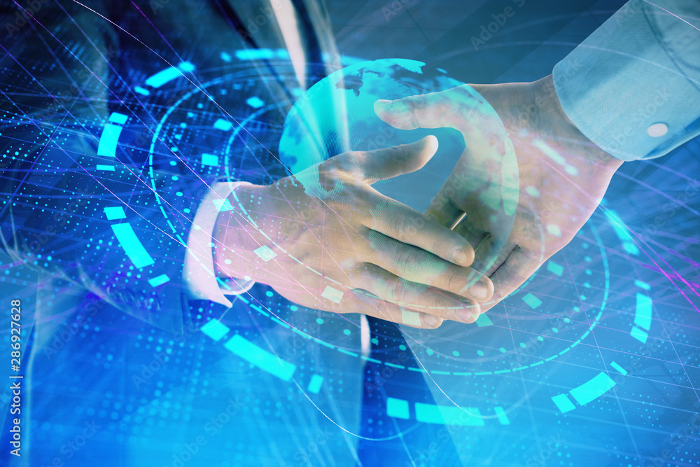 Multi exposure of world map on abstract background with two businessmen handshake. Concept of international business Multi exposure of world map on abstract background with two businessmen handshake. Concept of international business