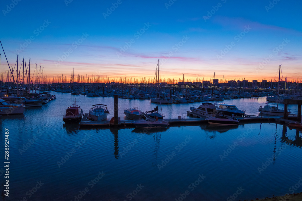 Colorful sunset in the old harbor of La Rochelle, France