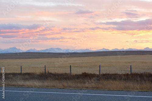 Beautiful Pastel Sunset On Praries with Mountains in Background