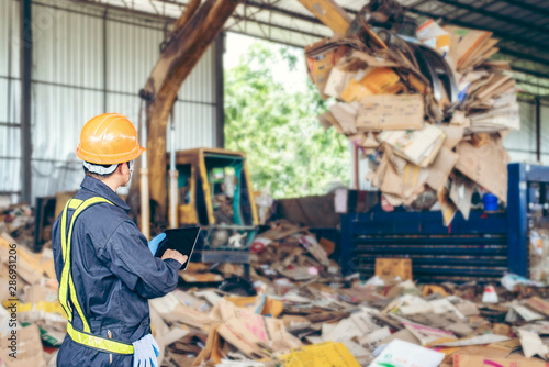 Engineer Standing to work with tablet Machines in the recycling industry photo