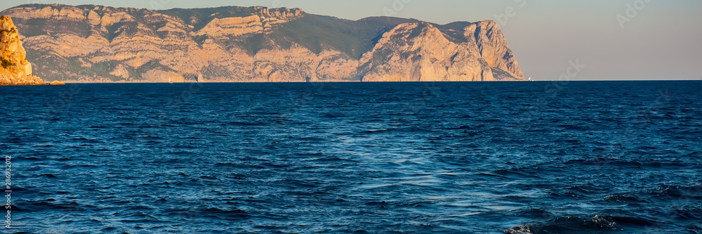 Obraz premium Seascape Water, Mountains and Yacht in the evening.