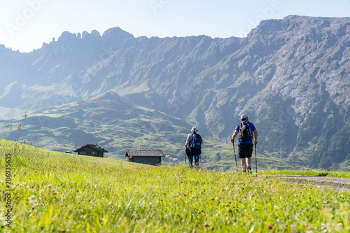 Two people hiking on the Seiser alm in south tyrol