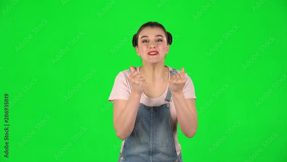 Cute female looking at the camera with excitement, then celebrating her victory triumph on green screen Cute female looking at the camera with excitement, then celebrating her victory triumph on green screen