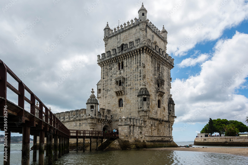 Belem Tower in Lisbon, Portugal with a blue cloudy sky