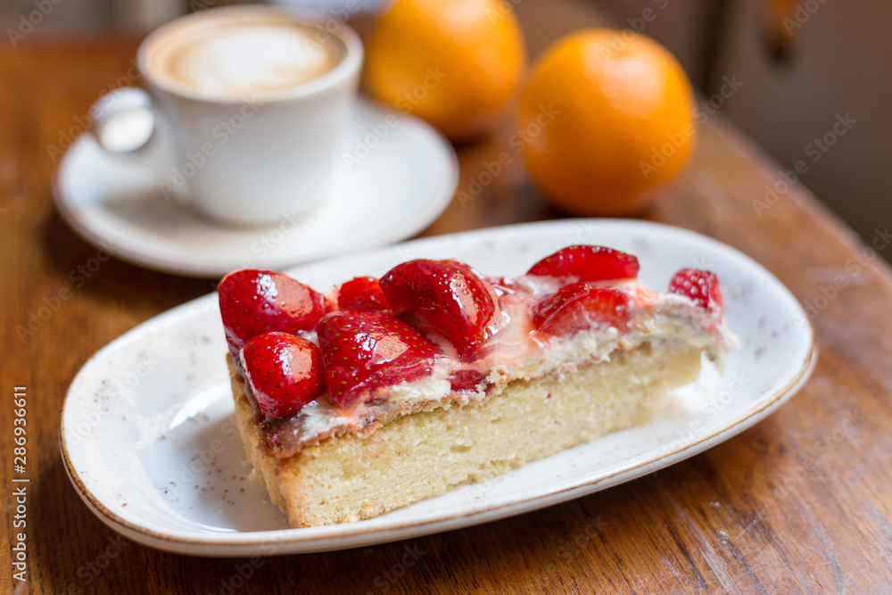 Close up strawberry cake and coffee latte art. Still life with a Cup of coffee and sweet dessert with strawberries Close up strawberry cake and coffee latte art. Still life with a Cup of coffee and sweet dessert with strawberries