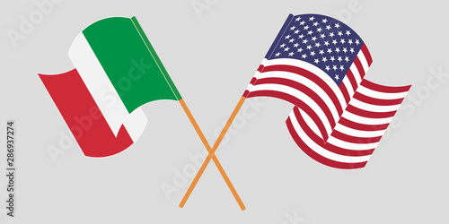 Crossed and waving flags of Italy and the USA