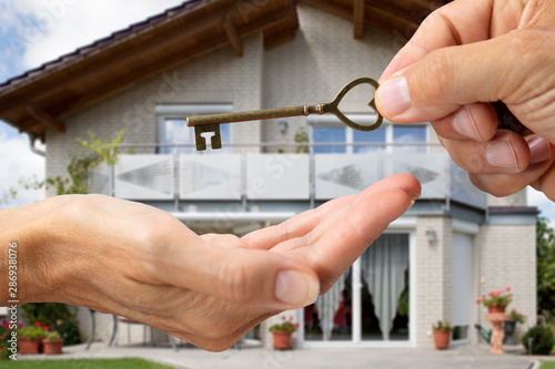 Bilde på lerret Person Hand Giving Home Key To A Client