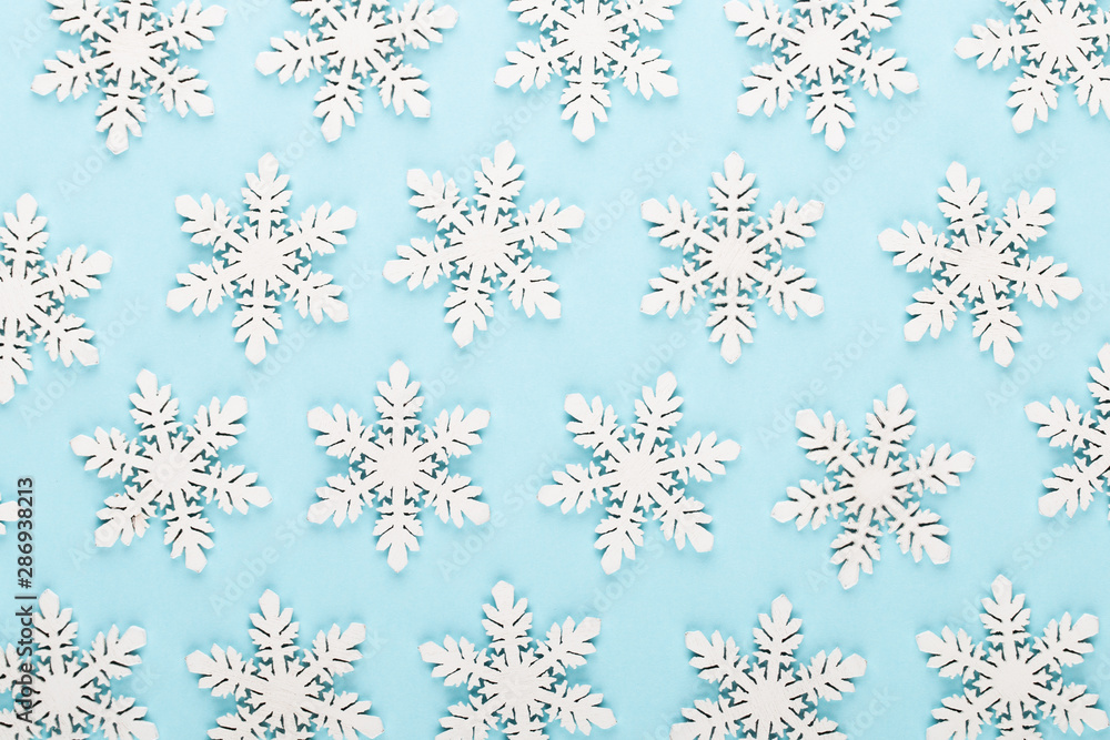 Christmas background. White snow decorations on a pink background. Christmas background. White snow decorations on a pink background.