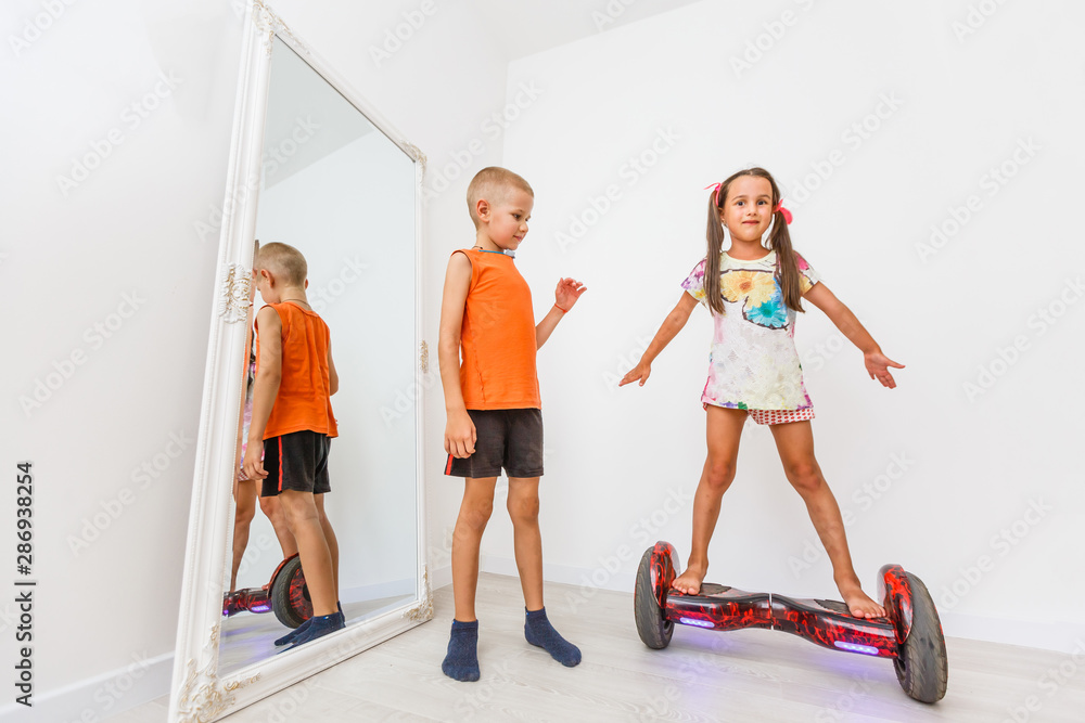 Fototapeta premium little girl on gyroboard on a white background