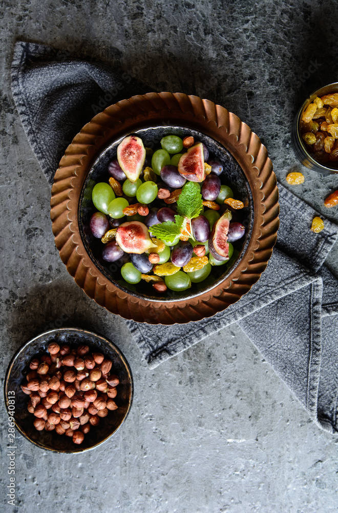 Fruit salad with green and red grapes, jumbo golden raisins, figs and hazelnuts