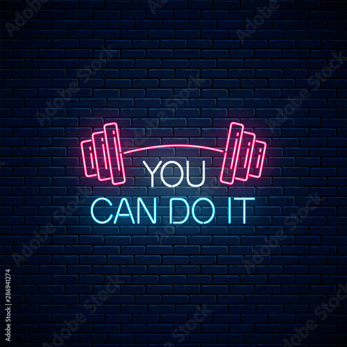 You can do it - glowing neon inscription phrase with barbell on dark wall background. Motivation quote in neon style.