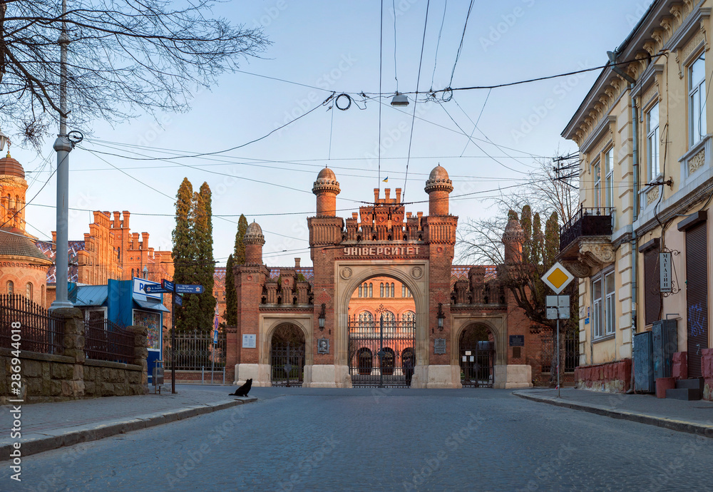 Fototapeta premium The Residency of the Chernivtsi National University. Saints Orthodox church in University. Exterior facade of Chernivtsi University from the street in the morning.