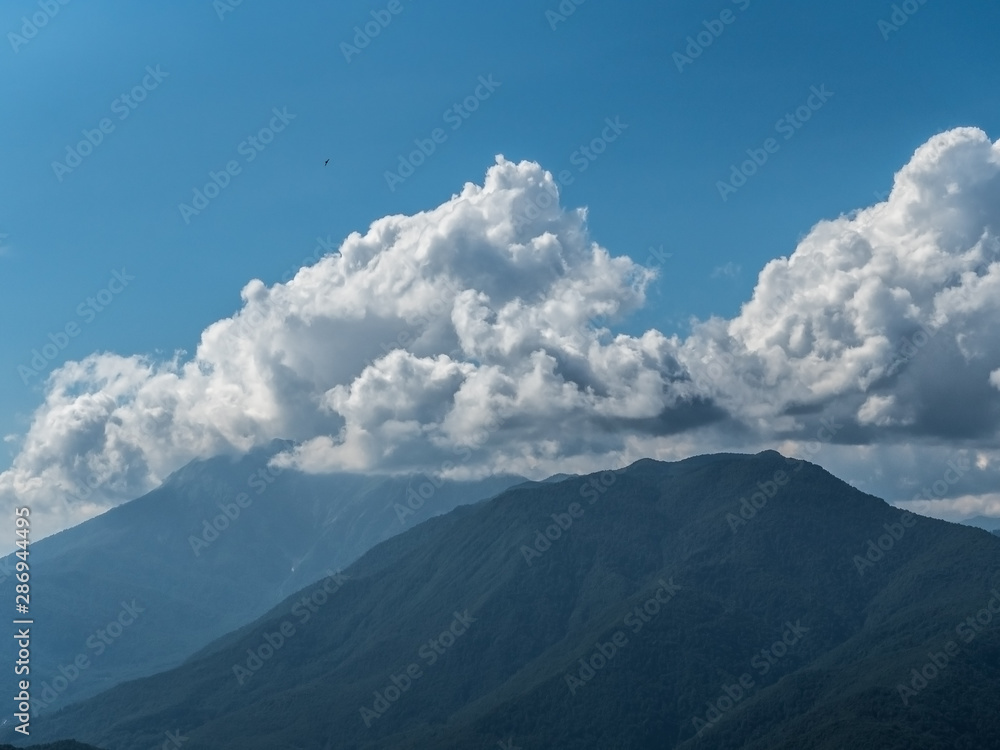 Beautiful green mountains and clouds in the resort of Rosa Khutor