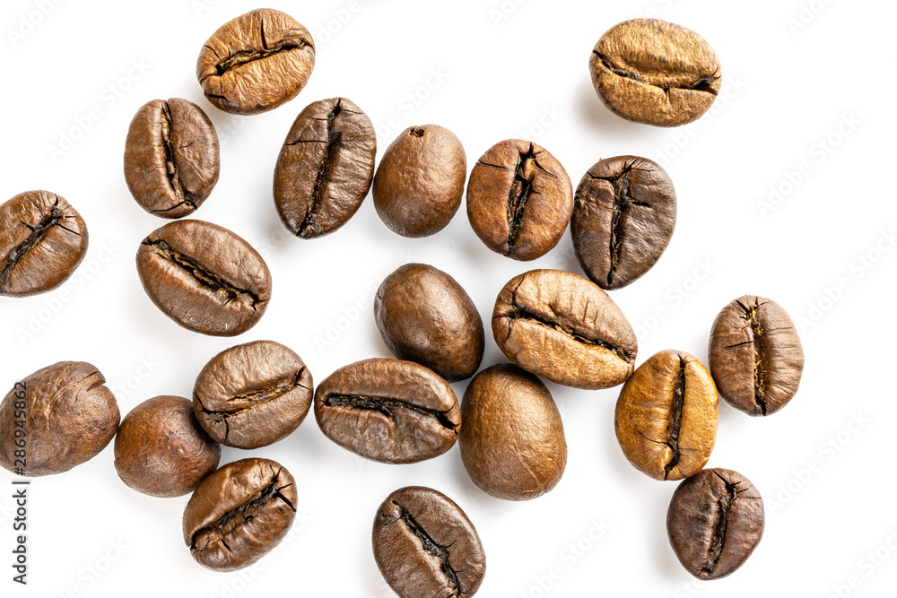 Roasted coffee beans isolated in white background cutout. Coffee background or texture concept. Roasted coffee beans isolated in white background cutout. Coffee background or texture concept.