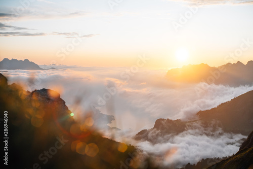 sunset in the mountains with a lake  walensee  under the clouds sea
