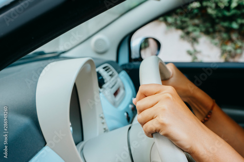 Woman driving her car. Leisure, road trip, travel, family and people concept. Student driver taking driving test.