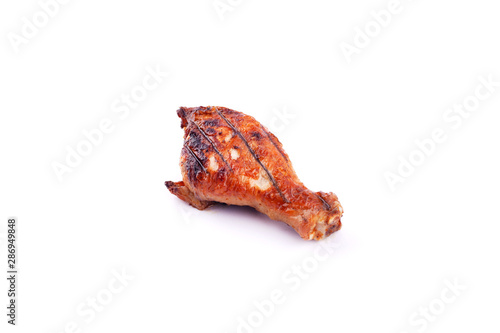 grilled chicken leg with crust on a white background isolated.