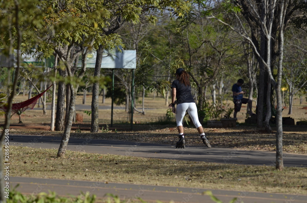A beautiful view of people walking with rollerblades in Brasilia park, Brazil