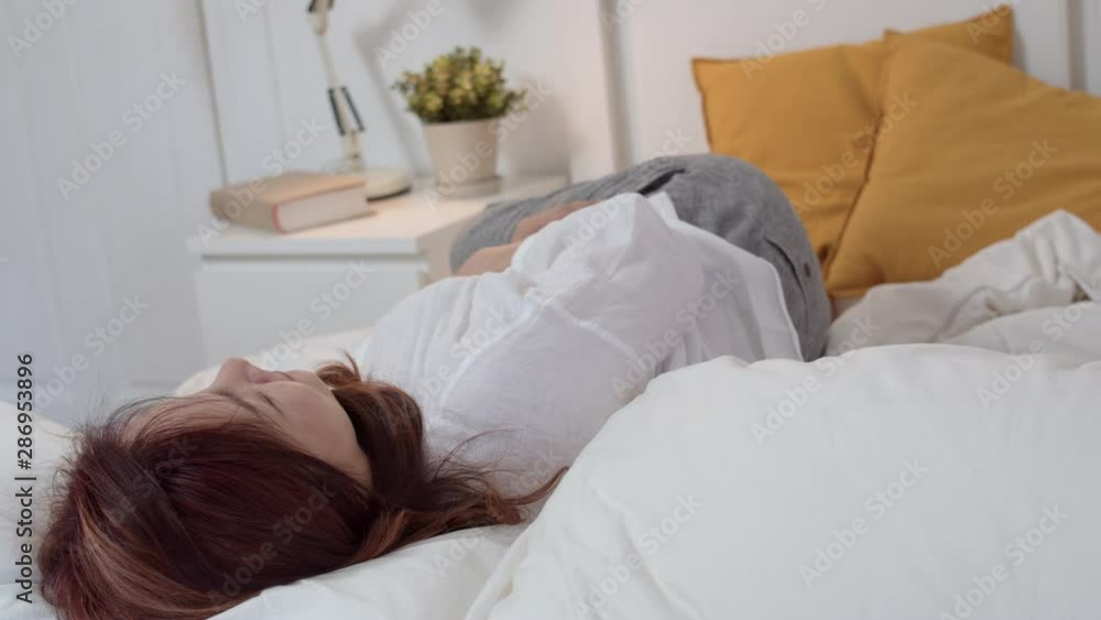 Asian grandmother sleep at home. Senior Chinese, grandma happy relax with young granddaughter girl kissing cheek for waking up lying on bed in bedroom at home at night concept. Slow motion. Asian grandmother sleep at home. Senior Chinese, grandma happy relax with young granddaughter girl kissing cheek for waking up lying on bed in bedroom at home at night concept. Slow motion.