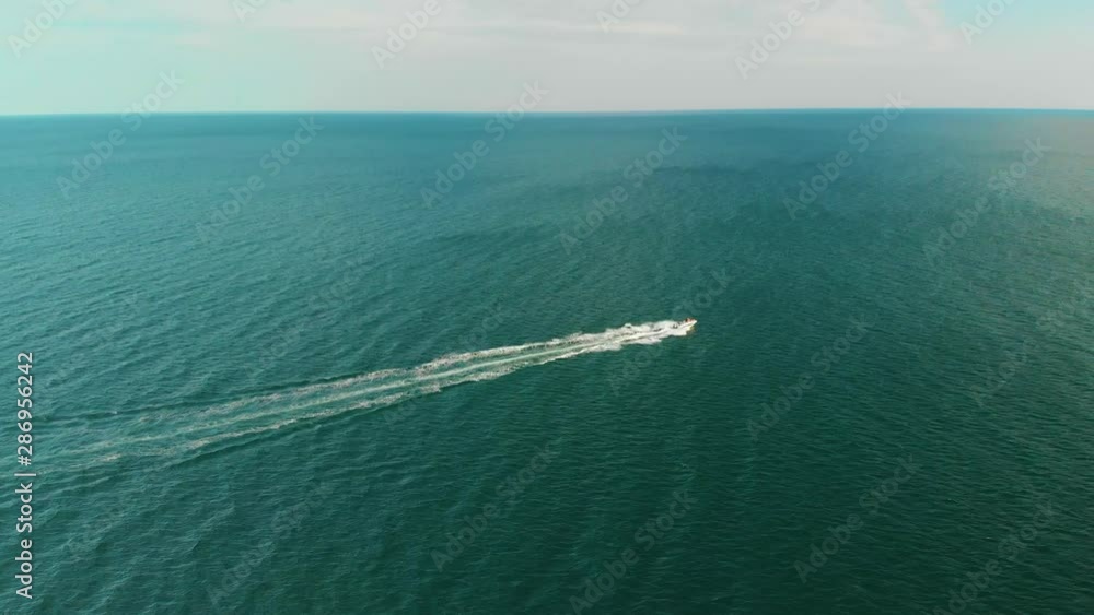Drone Aerial Shot of a Powerboat Motorboat Moving Fast in Turquoise Sea Drone Aerial Shot of a Powerboat Motorboat Moving Fast in Turquoise Sea