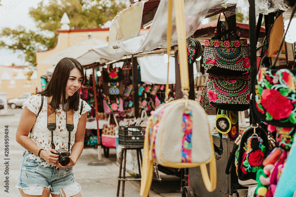Traveler Girl Buying Souvenirs In The Traditional Mexican Market In traveler-girl-buying-souvenirs-in-the-traditional-mexican-market-in
