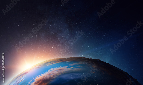 Fototapeta Naklejka Na Ścianę i Meble -  Earth with sunrise on blue space background