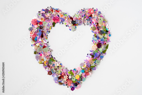 A heart shape made of glittering decoration on a white background. Festive and celebration, Valentine's Day concept. Love symbol.